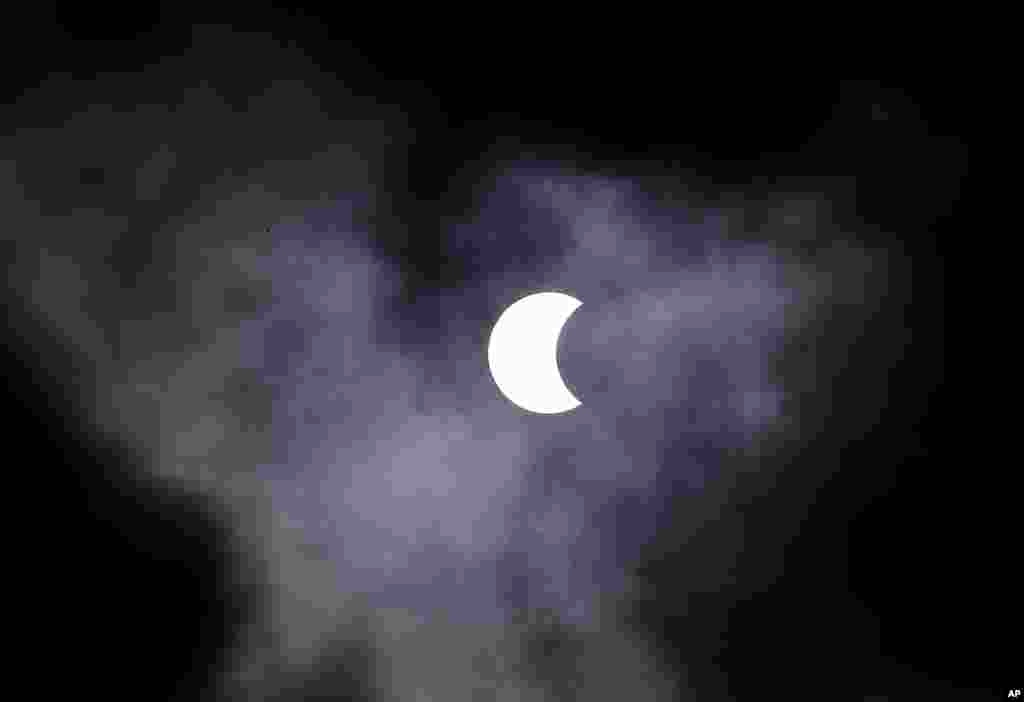 The moon passes in front of the sun, creating a solar eclipse visible in the southern hemisphere, seen from from Sao Paulo, Brazil.