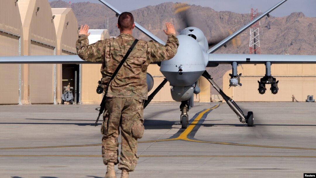 A U.S. airman guides a U.S. Air Force MQ-9 Reaper drone as it taxis to the runway at Kandahar Airfield, Afghanistan, March 9, 2016. 