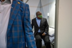 FILE - South African President Cyril Ramaphosa visits the COVID-19 treatment facilities at the NASREC Expo Centre in Johannesburg, South Africa, April 24, 2020.