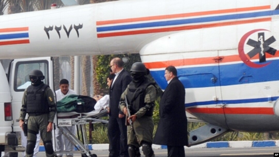 Former Egyptian president Hosni Mubarak is carried from an ambulance to a helicopter for his trial in Cairo, Egypt, Thursday, Jan. 5, 2012.