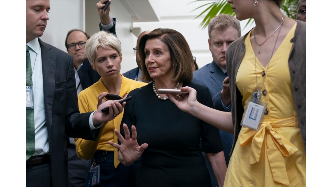 Speaker of the House Nancy Pelosi, D-Calif., is surrounded by reporters as she arrives to meet with her caucus at the Capitol in Washington, after declaring she will launch a formal impeachment inquiry against President Donald Trump.