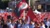 Demonstrators at Taksim Square wave flags bearing the face of Mustafa Kemal Ataturk, revered as founder of the modern Turkish Republic, July 24, 2016. Many are calling for preservation of the secular state established by Ataturk nearly a century ago. (L. Ramirez/VOA)