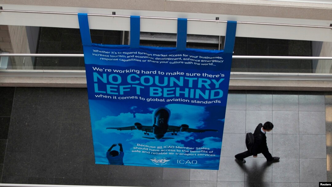 FILE - A delegate walks past a banner during a break at the International Civil Aviation Organization's (ICAO) global safety meeting in Montreal, Feb. 4, 2015. Taiwan has not been invited to attend the upcoming event Sept. 27, following pressure from China.