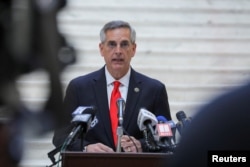 FILE - Georgia Secretary of State Brad Raffensperger gives an update on the state of the election and ballot count during a news conference at the State Capitol in Atlanta, Georgia, Nov. 6, 2020.