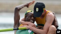 South African rowers Sizwe Ndlovu, left, and John Smith embrace after winning the gold medal in the men's lightweight four rowing final at the London 2012 Summer Olympics, August 2, 2012.