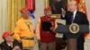 President Donald Trump, right, speaks during a meeting with Navajo Code Talkers including Fleming Begaye Sr., seated left, Thomas Begay, second from left, and Peter MacDonald, second from right, in the Oval Office of the White House, Nov. 27, 2017. 