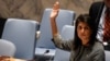 FILE - U.S. Ambassador to the U.N. Nikki Haley votes for a draft resolution condemning the reported use of chemical weapons in Syria at the Security Council meeting on the situation in Syria at the United Nations Headquarters in New York, April 12, 2017. 