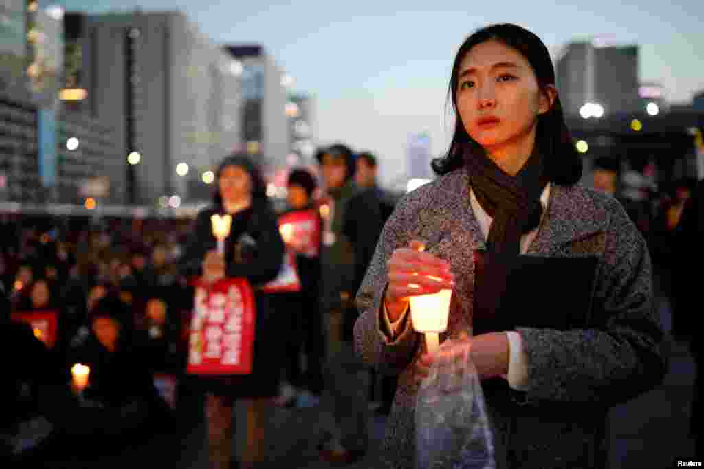 People attend a rally calling for impeached President Park Geun-hye's arrest in central Seoul, South Korea.