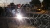 Egyptian Army soldiers install barbed wire outside the presidential palace to secure the site of overnight clashes between supporters and opponents of President Mohammed Morsi in Cairo, Egypt, Thursday, Dec. 6, 2012.