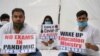 Activists of the National Students Union of India (NSUI) stage a protest in front of the NSUI headquarters in New Delhi, India, Aug. 26, 2020, demanding the government postpone entrance exams.