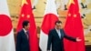 Japanese Prime Minister Shinzo Abe, left, and Chinese Premier Li Keqiang prepare to leave after attending a signing ceremony at the Great Hall of the People in Beijing, Oct. 26, 2018.