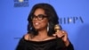 Oprah Winfrey poses in the press room with the Cecil B. DeMille Award at the 75th annual Golden Globe Awards at the Beverly Hilton Hotel on Jan. 7, 2018, in Beverly Hills, Calif.