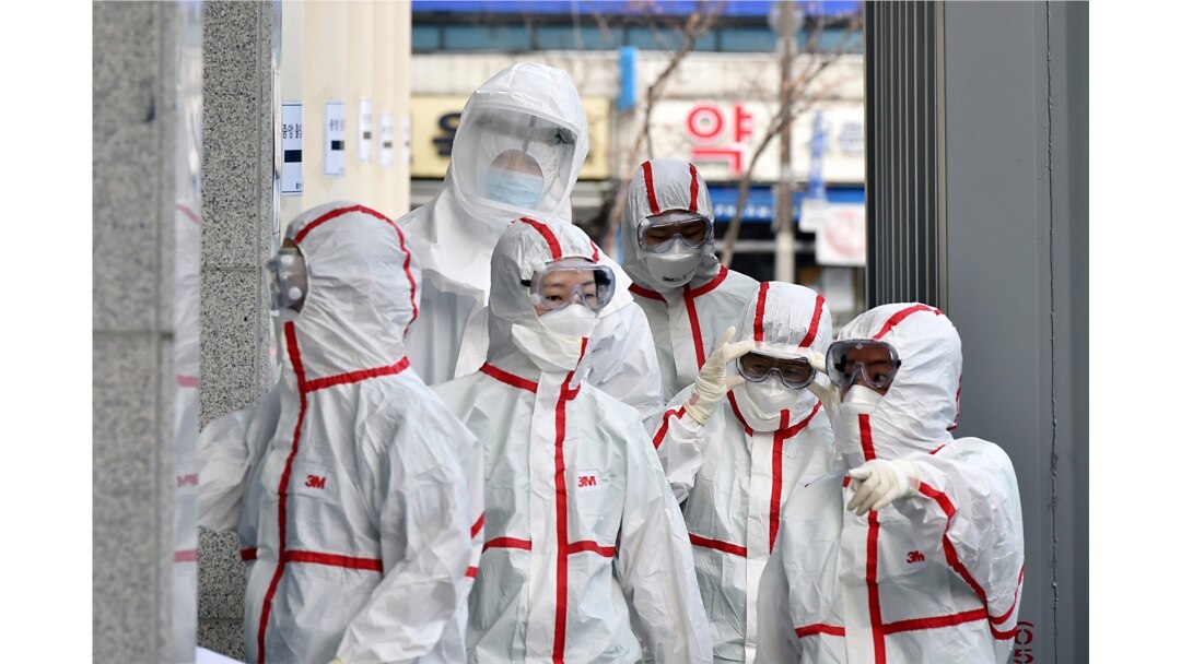 Medical staff members in protective gears arrive for a duty shift at Dongsan Hospital in Daegu, South Korea, March 3, 2020.