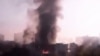 In this image taken from video obtained from the Syria 2011 Archives, which has been authenticated based on its contents and other AP reporting, black smoke rises from Syria's army command headquarters in Damascus, Syria, on Sept. 26, 2012. 