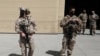 FILE - U.S. troops stand guard during a handover ceremony of A-29 Super Tucano planes from U.S. to the Afghan forces, in Kabul, Sept. 17, 2020. 