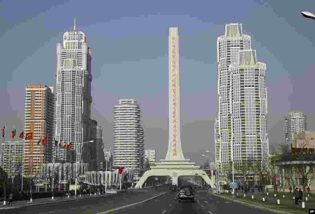 Vehicles travel down a main road which leads towards North Korea's newest residential development, Ryomyong Street in Pyongyang, North Korea.