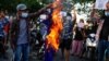 FILE - Protesters against Myanmar's junta burn the flag of the Association of Southeast Asian Nations (ASEAN), in Mandalay.