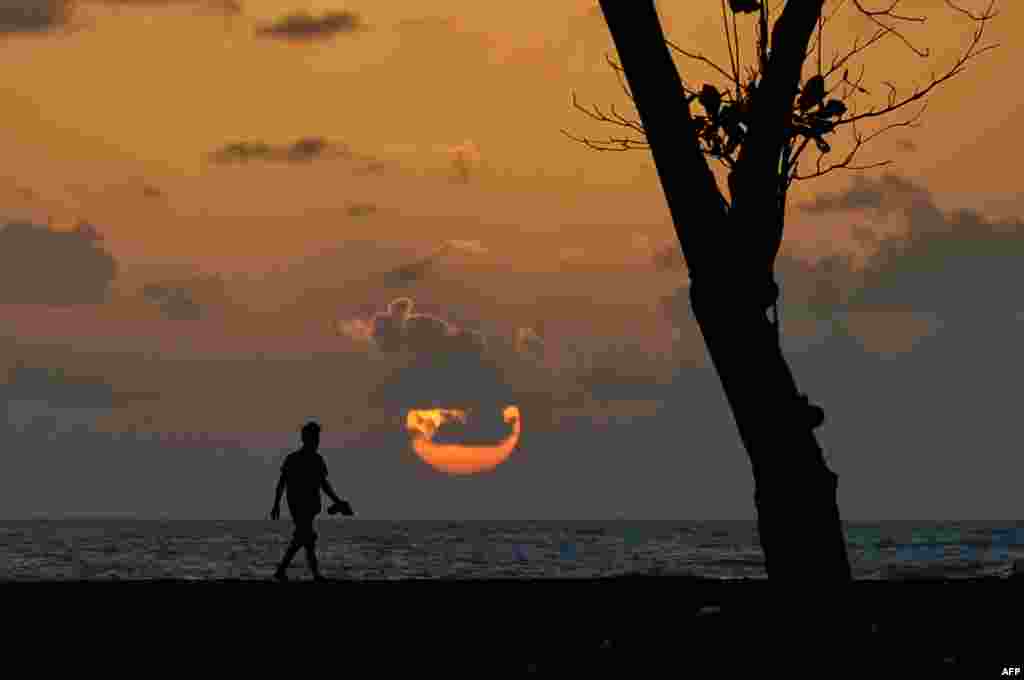 An Acehnese man watches the sunset at Meulaboh beach in Indonesia&#39;s Aceh province.