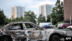 Damaged car in northern neighborhood of Amiens, France, August 15, 2012.