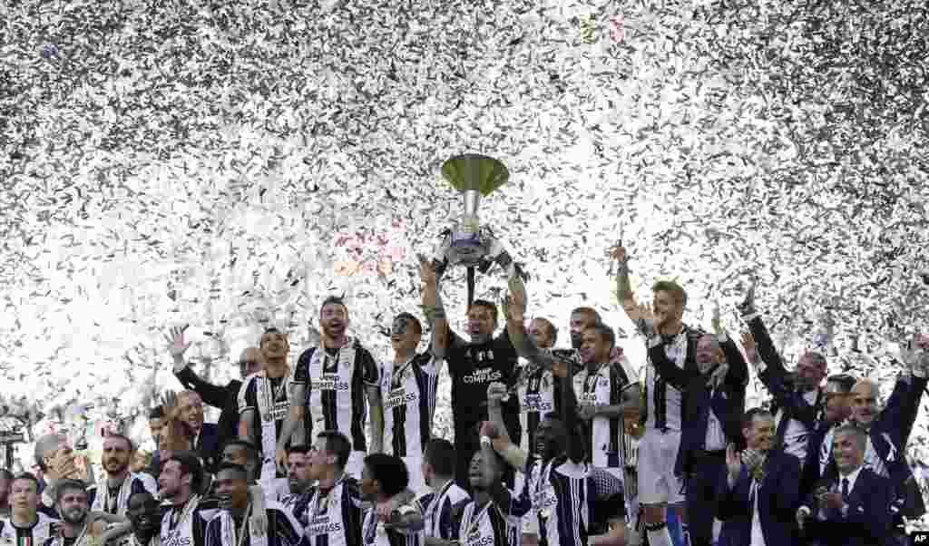 Juventus players celebrate winning an unprecedented sixth consecutive Italian title, at the end of the Serie A soccer match between Juventus and Crotone at the Juventus stadium, in Turin, Italy.