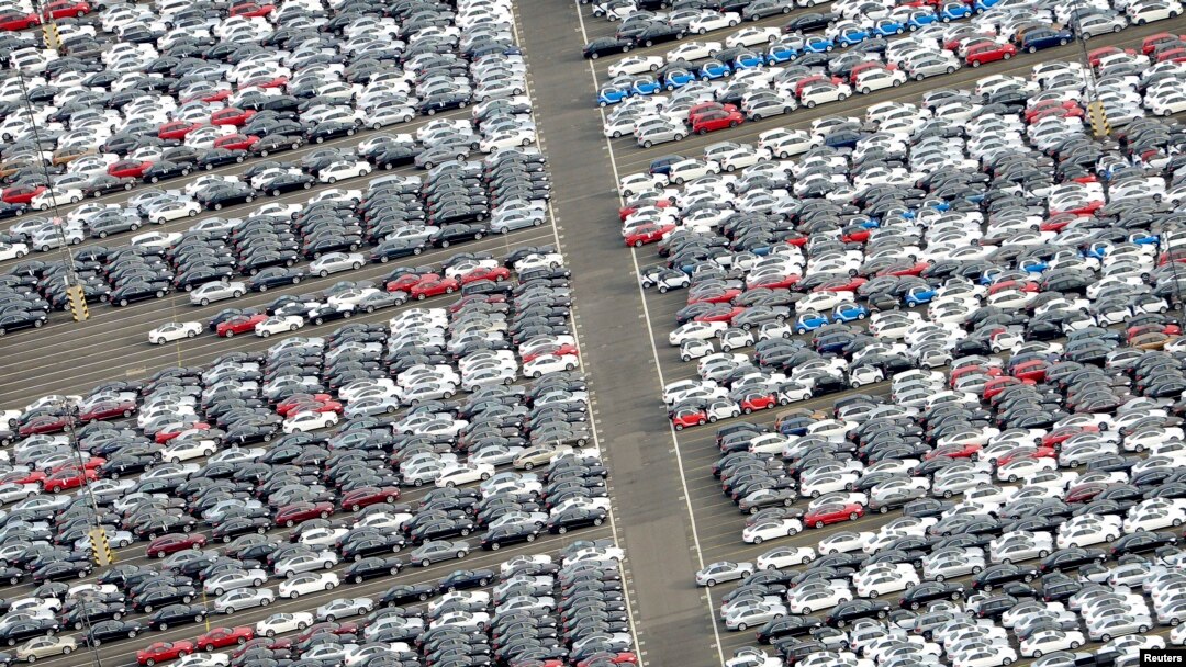 FILE - Cars for export stand in a parking area at a shipping terminal in the harbor of the northern German town of Bremerhaven, Oct. 8, 2012. 