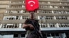 FILE - A Turkish special forces policeman stands guard in front of a damaged building inside the special forces policemen base, which was attacked during the failed military coup earlier this month, in Ankara, Turkey, July 19, 2016. Despite the chaos within the Turkish military, the PKK Kurdish rebel group has not launched any major attacks.