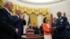 Gen. Charles Brown Jr., right, is sworn in as Chief of Staff of the Air Force in the Oval Office of the White House, with his wife Sharene Guilford Brown holding the Bible, in Washington, Aug. 4, 2020.