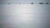 FILE - A fishing boat motors back to shore on the east coast of Natuna Besar.