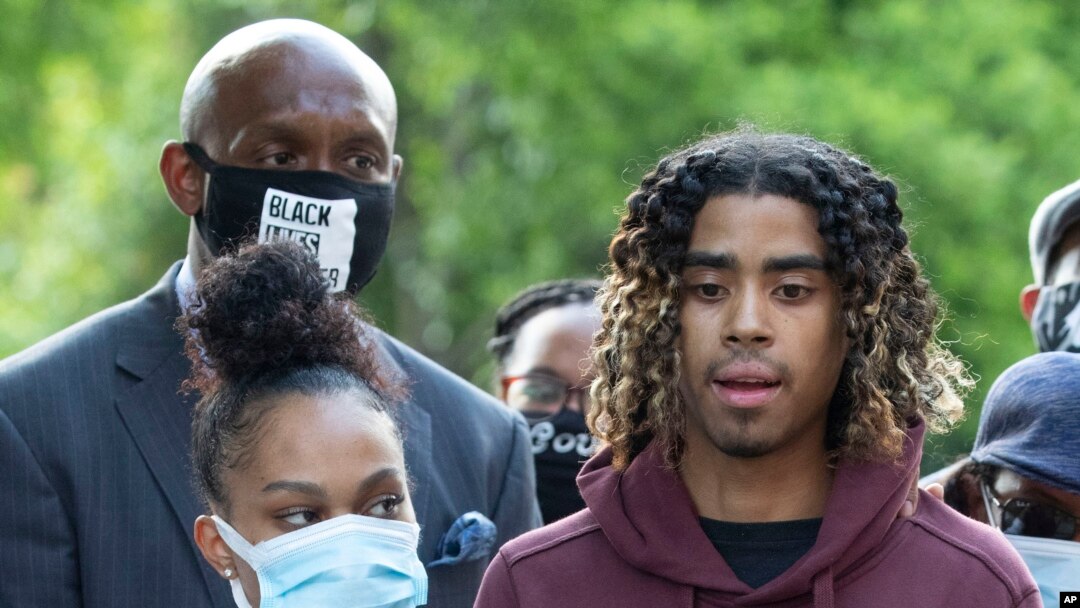 Taniyah Pilgrim listens to Messiah Young as he speaks during a news conference on the campus of Morehouse College, June 1, 2020, in Atlanta.