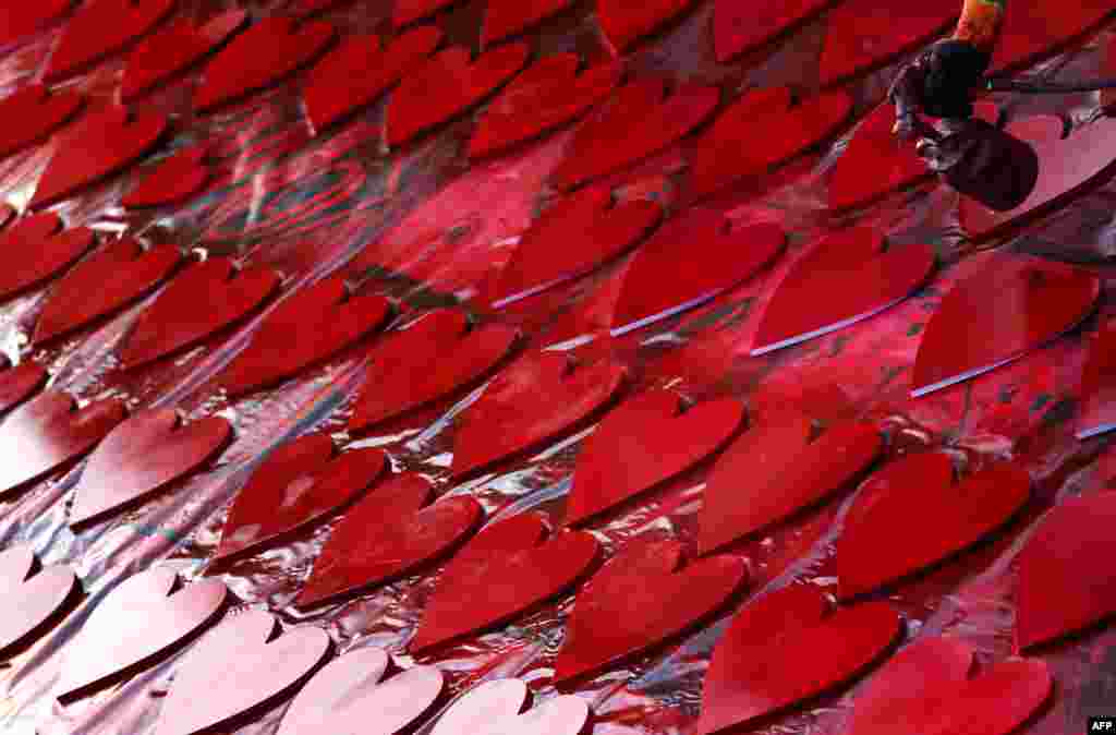An Iraqi Kurdish man spray-paints hearts in anticipation for Valentine's Day, in a street in Arbil, the capital of the Kurdish autonomous region in northern Iraq.