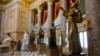 FILE - A statue of missionary Junipero Serra, right, is seen in Statuary Hall, also known as the Old Hall of the House, on Capitol Hill in Washington, D.C., July 2, 2015. 