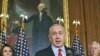 Israeli Prime Minister Benjamin Netanyahu, accompanied by House of Representatives members, gestures during a news conference on Capitol Hill in Washington, March 6, 2012.