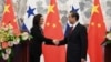 Panama's Foreign Minister Isabel de Saint Malo, left, shakes hands with her Chinese counterpart Wang Yi during a joint press briefing after signing a joint communique on establishing diplomatic relations, in Beijing, June 13, 2017.