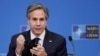 FILE - U.S. Secretary of State Antony Blinken removes his mask as gives a press briefing at the end of a NATO Foreign Ministers' meeting at the Alliance's headquarters in Brussels, Belgium, March 24, 2021.
