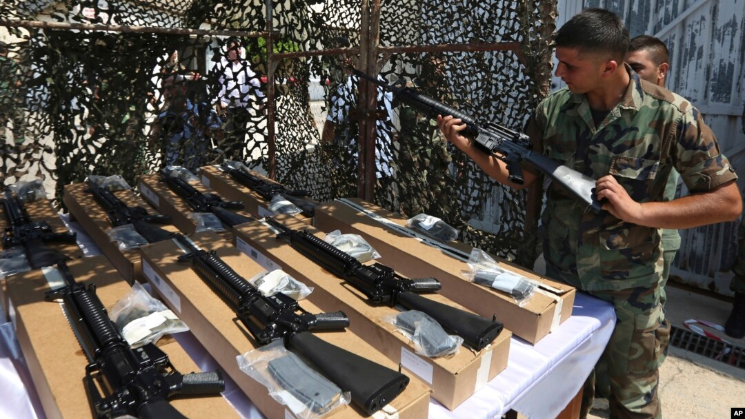 A Lebanese army soldier inspects a rifle as part of the first shipment of weapons from the U.S. to Lebanon to help bolster its military as the country faces a growing threat from Islamic militants, at the Rafik Hariri International Airport in Beirut, Lebanon, Aug. 29, 2014.
