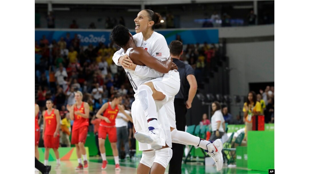 United States' Diana Taurasi, right, leaps into the arms of teammate Angel McCoughtry as they celebrate their win over Spain in a women's gold medal basketball game at the 2016 Summer Olympics in Rio de Janeiro, Brazil, Aug. 20, 2016.