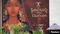 People are seen outside a Tanishq jewelry store in Mumbai, India, Oct. 14, 2020. 