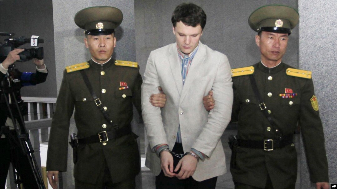 American student Otto Warmbier, center, is escorted at the Supreme Court in Pyongyang, North Korea, March 16, 2016. North Korea's highest court sentenced Warmbier to 15 years in prison after he allegedly attempted to steal a propaganda banner.