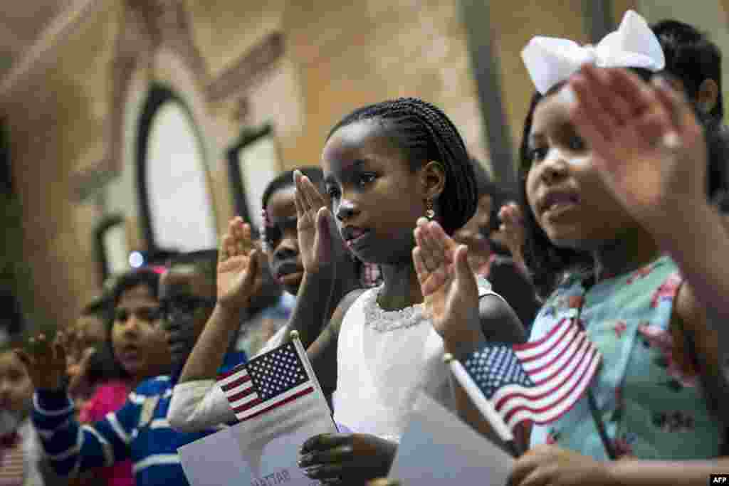 Children take the Oath of Allegiance as they become U.S. citizens during a citizenship ceremony at The Bronx Zoo, in The Bronx borough of New York City.&nbsp; Thirty-two children, ranging in age from 5 to 13 years old, attended the ceremony and became citizens.