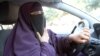 File - Kenza Drider, wearing a niqab, drives a car in Avignon, southern France.