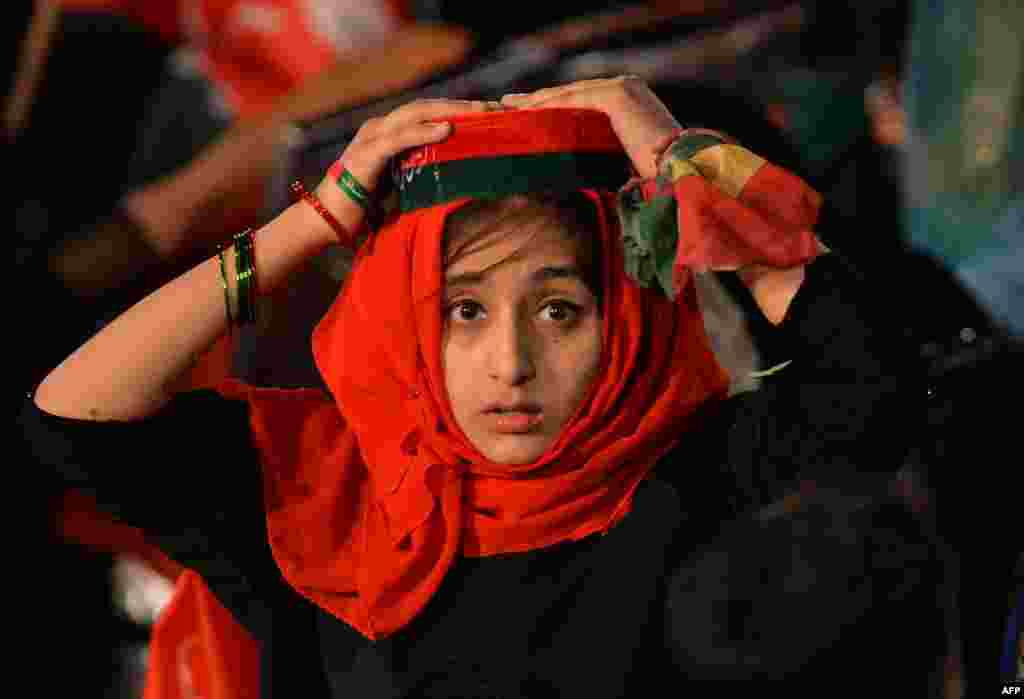 A young supporter of Pakistani cricketer-turned-opposition leader and head of the Pakistan Tehreek-i-Insaf (PTI) Imran Khan attends an anti-governement rally in Islamabad.