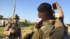 Iraqi soldiers waiting to deploy to the front lines take selfies and tell stories, anxious to get back into the action after weeks of waiting, in Mosul, Iraq, May 4, 2017. (H. Murdock/VOA)