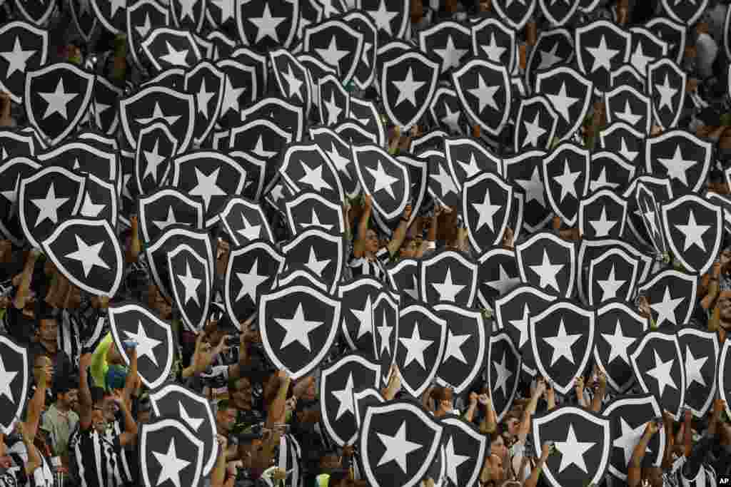 Fans of Brazil's Botafogo cheer before the Copa Libertadores soccer match against Ecuador's Barcelona at the Nilton Santos stadium, in Rio de Janeiro, Brazil, May 2, 2017.
