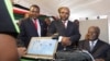 Kenyan President Mwai Kibaki (R) registers as a voter before launching the nationwide, one-month biometric voter registration (BVR) exercise in the capital Nairobi, November 19, 2012, targeting over 18 million voters ahead of the March 4 General Election.
