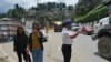 A traffic policewoman wearing a face mask controls the flow of traffic in Kohima, capital of the northeastern Indian state of Nagaland, May 29, 2020. 