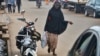 FILE - A Muslim woman walks in the Brituetterie district of Yaounde, Cameroon, July 16, 2015.