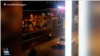 In this screen grab of a video shared on social media and vetted by the Associated Press, an Iranian policeman apparently stands in the street in Susangerd after firing in the air toward protesters who run away from him on July 18, 2021. 
