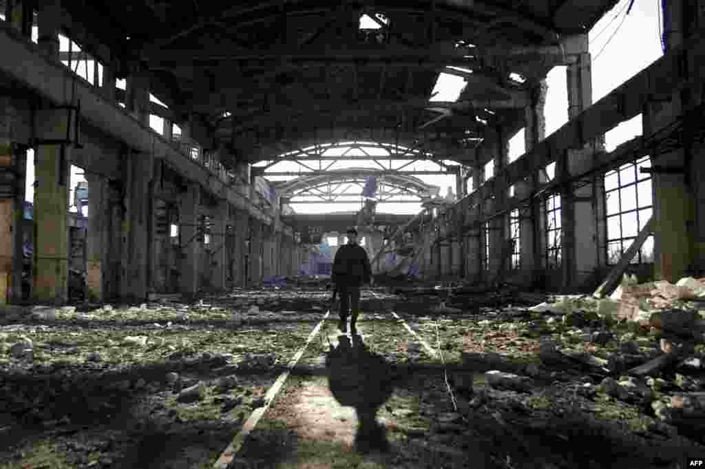 An Ukrainian serviceman walks through the rubble of a destroyed workshop after fighting with pro-Russian separatists in Avdiivka, Donetsk region.