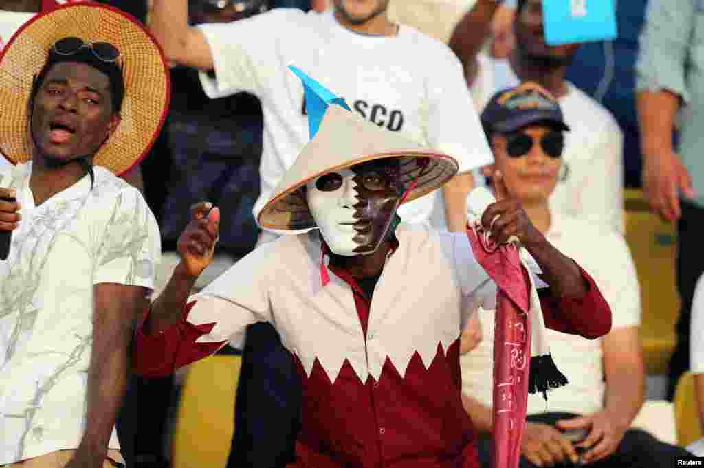 Migrant workers cheer before the start of the final soccer match between Al Asmakh Facilities Management and Nakheel Landscapes at the Workers' Cup in Doha, Qatar.