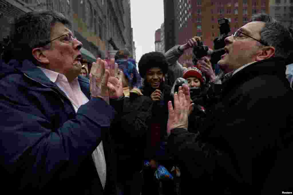 A supporter of President Donald Trump (R) argues with a protester as New York City high school students look on during a demonstration against Trump's immigration policies, in lower Manhattan, New York, Feb. 7, 2017.